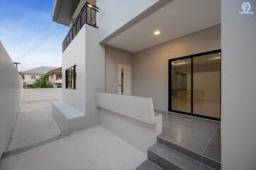 Modern residential building exterior with outdoor stairs and entryway