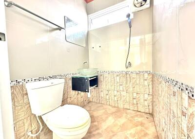 Modern tiled bathroom with a toilet and a shower