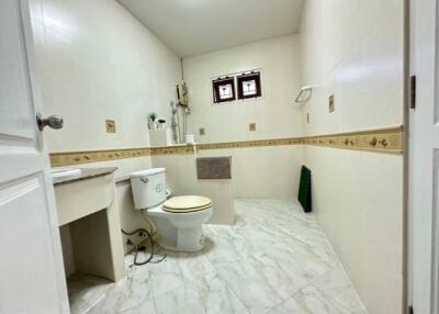 Spacious bathroom with marble flooring and decorative tiling