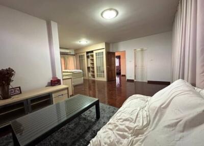 Cozy bedroom with an en-suite bathroom, wooden flooring, and modern furnishings