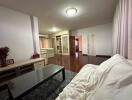 Cozy bedroom with an en-suite bathroom, wooden flooring, and modern furnishings