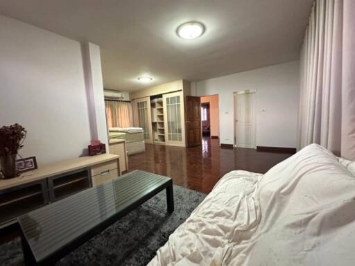 Cozy bedroom with an en-suite bathroom, wooden flooring, and modern furnishings