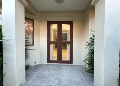Warmly inviting entrance with double doors and tranquil lighting