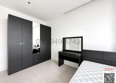 Modern bedroom interior with large wardrobe and vanity