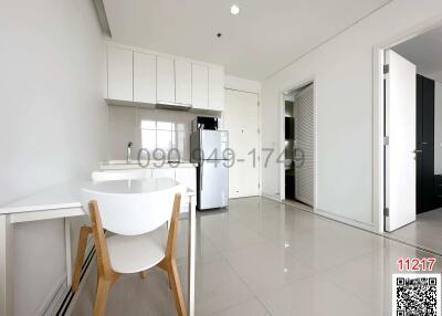 Modern kitchen with white cabinetry and breakfast bar in a bright apartment