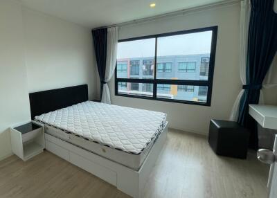 Modern bedroom with large window and ample natural light