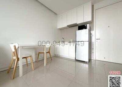 Modern minimalist kitchen with white cabinetry and appliances