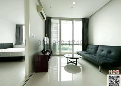 Spacious bedroom with modern furniture and ample natural light