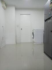 Compact laundry room with white washing machine and modern appliances