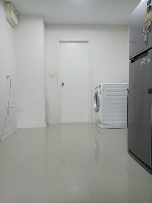 Compact laundry room with white washing machine and modern appliances