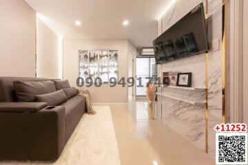 Contemporary living room with sleek furniture and wall-mounted television