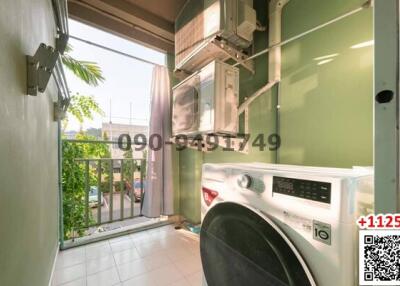 Compact balcony with laundry appliances and outdoor view
