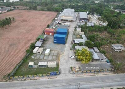 Aerial view of industrial compound with warehouses and containers