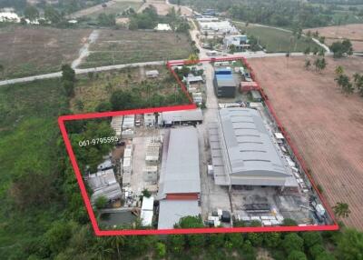 Aerial view of industrial property with warehouses and open lots