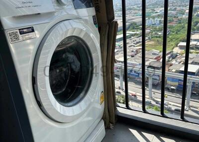 Washing machine on apartment balcony with urban background