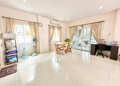 Spacious and bright living room with dining area and tiled flooring
