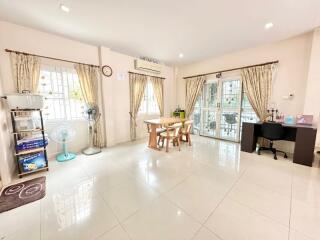 Spacious and bright living room with dining area and tiled flooring