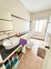 Spacious tiled bathroom with natural light