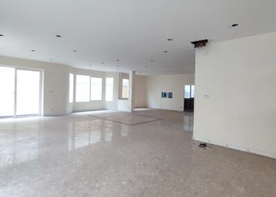 Spacious unfurnished living room with large windows and marble flooring
