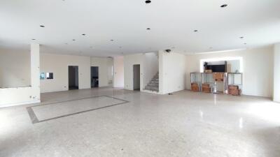 Spacious living room with marble flooring and natural light