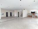 Spacious living room with marble flooring and natural light