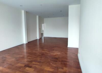 Spacious unfurnished living room with hardwood floors and natural light