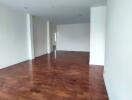 Spacious unfurnished living room with hardwood floors and natural light