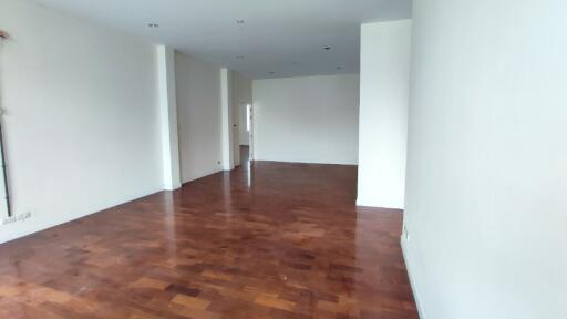 Spacious unfurnished living room with hardwood floors and natural light