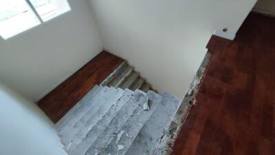 Empty bedroom with unfinished flooring and repair work in progress