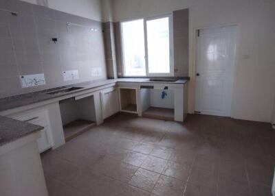 Empty spacious kitchen with tiled flooring