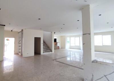Spacious unfurnished living area with open floor plan and staircase