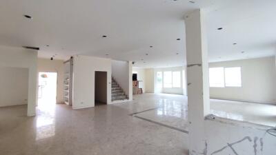 Spacious unfurnished living area with open floor plan and staircase