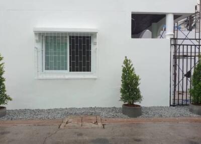 White building facade with window and secure gate