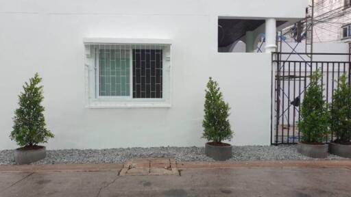 White building facade with window and secure gate