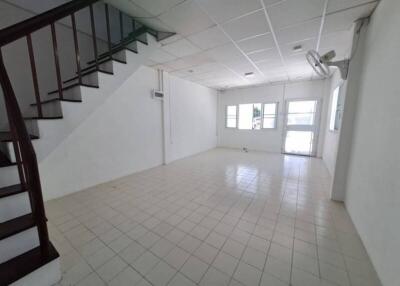 Spacious living room with staircase and tiled flooring