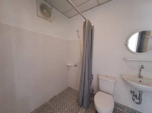 Compact bathroom with shower, toilet and sink