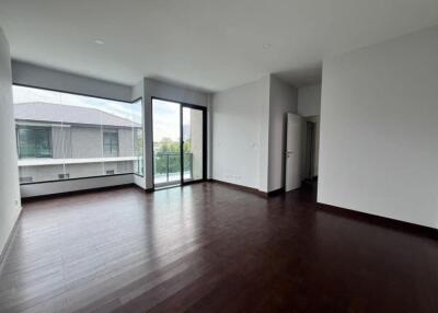 Spacious empty living room with hardwood floors and ample natural light