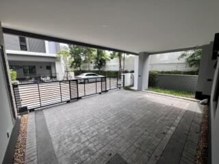 Spacious covered carport area with paved flooring