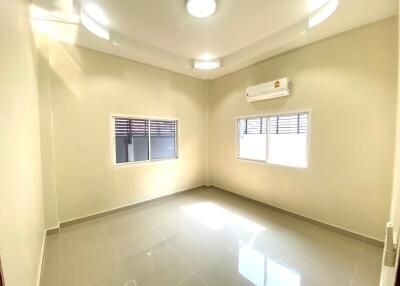 Bright empty bedroom with tiled floor