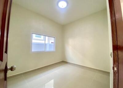 Empty bedroom with tiled flooring and good natural lighting