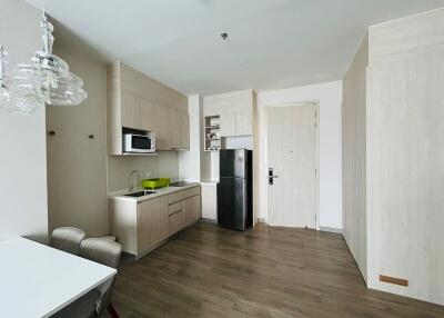 Modern kitchen with integrated appliances and wooden flooring