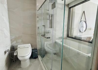 Modern bathroom with glass shower cabin and toilet
