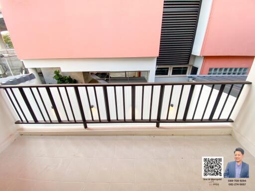 Compact balcony overlooking the building facade with metal railing