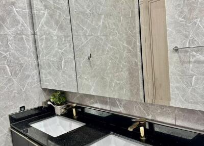 Modern bathroom with dual sinks and marble finishing