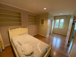 Cozy bedroom with hardwood floors and ample natural light