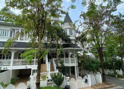 Victorian style residential building with lush greenery