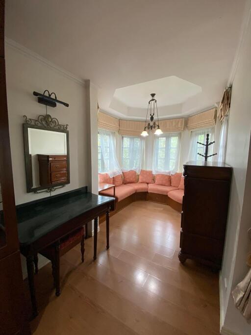 Cozy and well-lit living room with a bay window