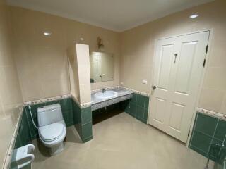 Spacious bathroom with neutral color tiles and modern fixtures