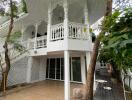 Two-story house with balcony and outdoor seating area