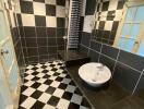 Black and white tiled bathroom with shower and sink